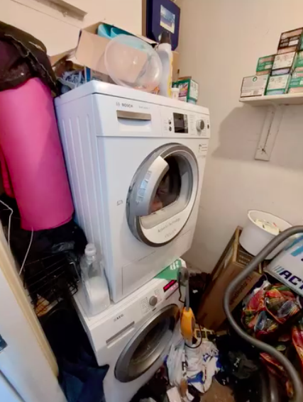 Cluttered laundry room before organising